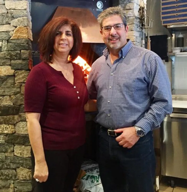 Nick and Catherine Markantonis, owners of Asti, beside their coal-fired oven